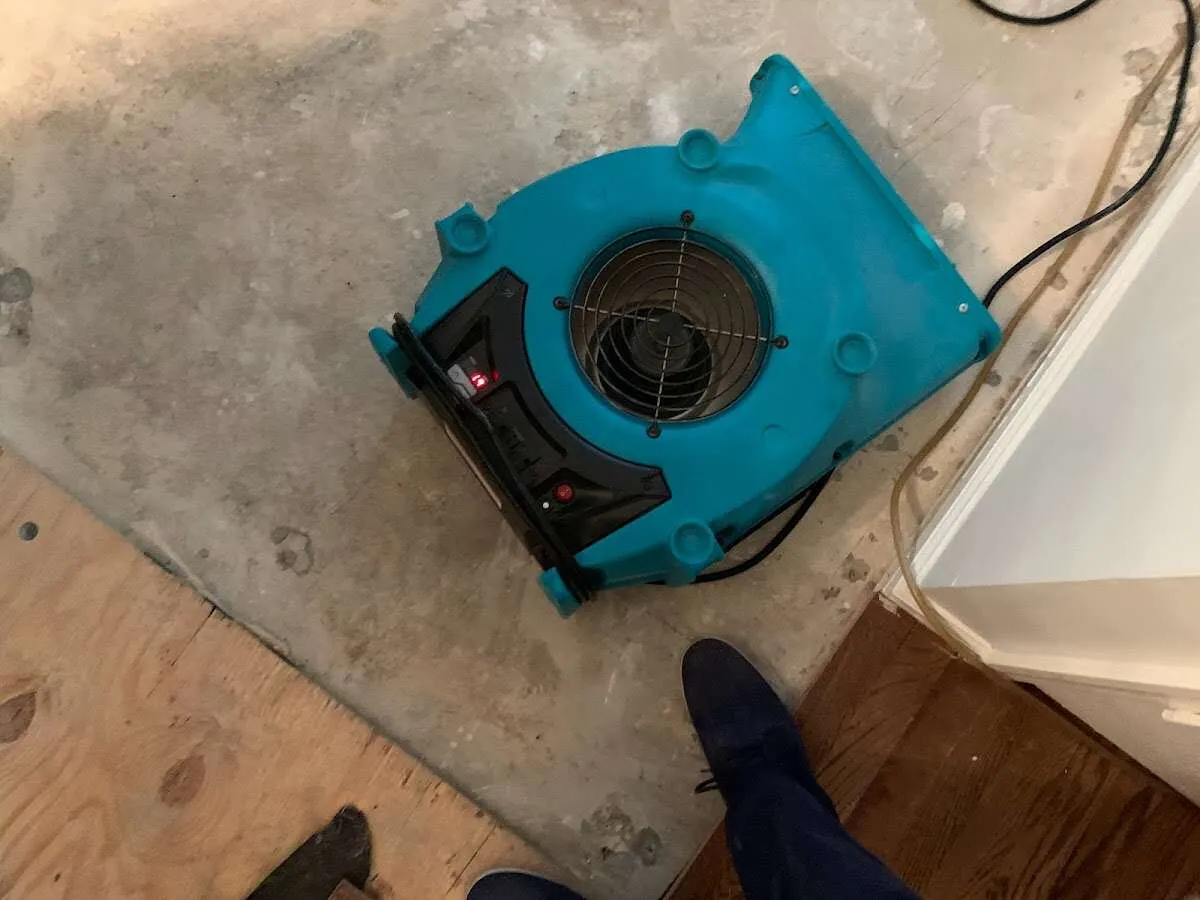 Air mover drying subfloor during Commercial Water Damage Restoration in New Gloucester